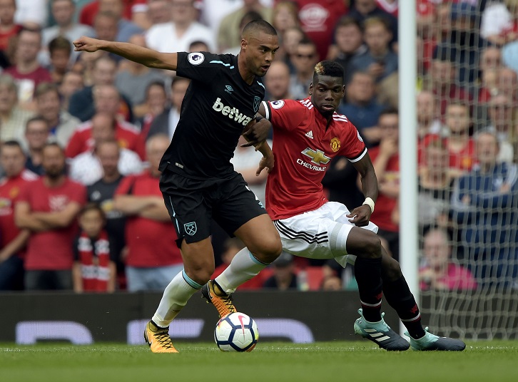 Winston Reid holds of Paul Pogba at Old Trafford in August 2017
