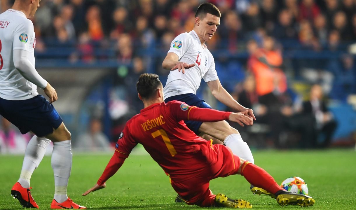 Declan Rice makes a tackle against Montenegro