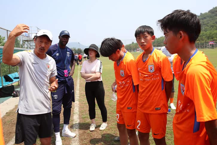 Carlton Cole with youngsters in China