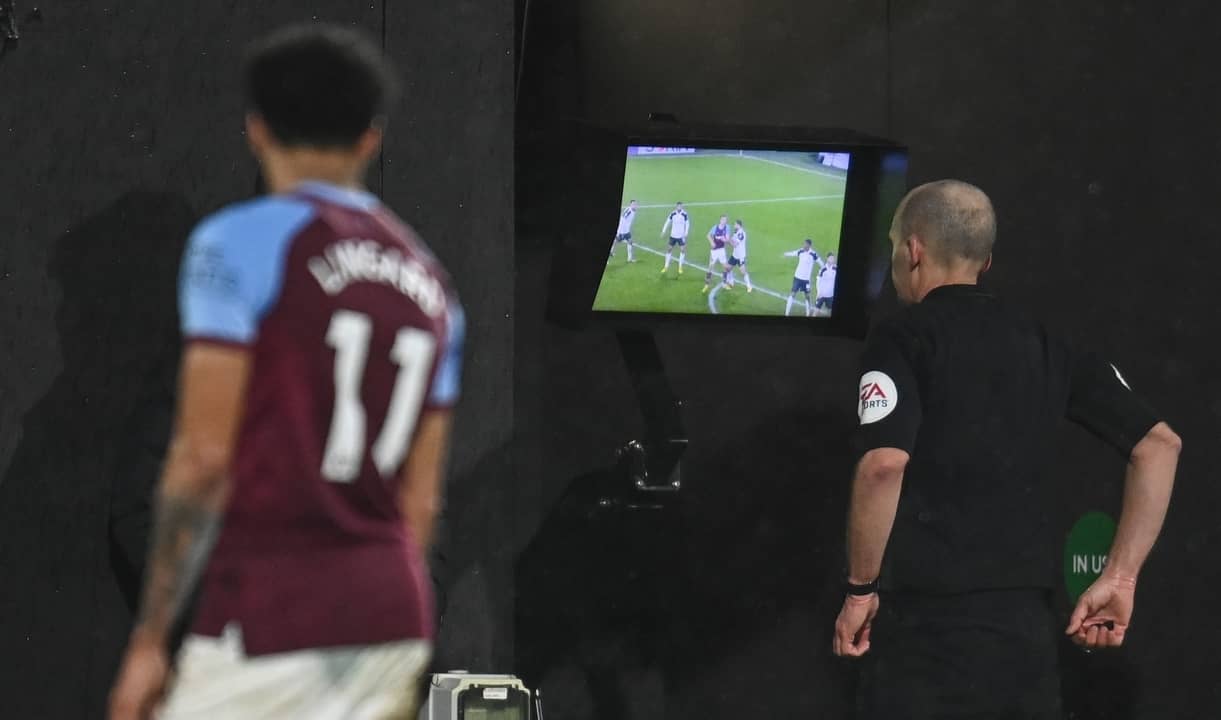 Referee Mike Dean checks the VAR monitor