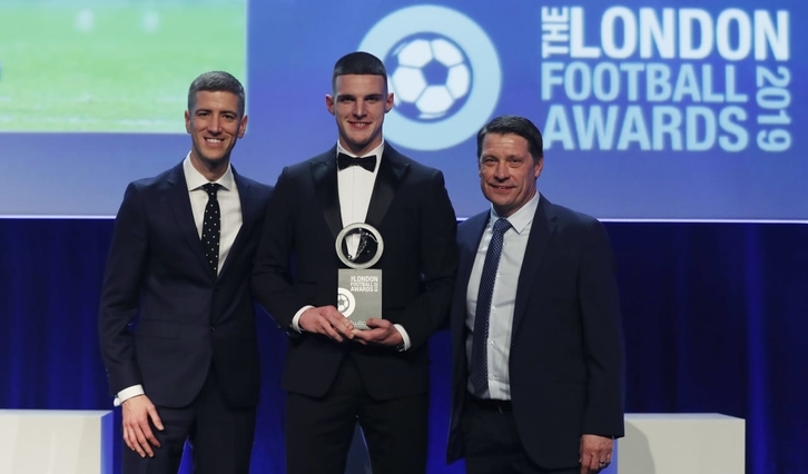 Declan Rice poses with Tony Cottee and a representative from award sponsor Zeus Capital after winning the Young Player of the Year at the London Football Awards 2019. Credit: Action Images