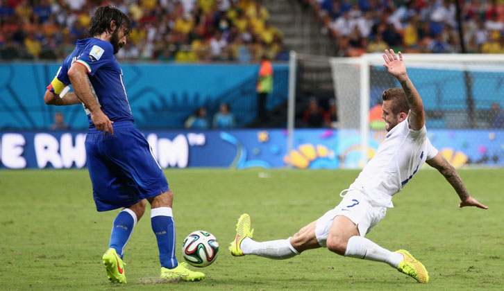 Jack Wilshere challenges Andrea Pirlo during England's 2014 FIFA World Cup clash with Italy