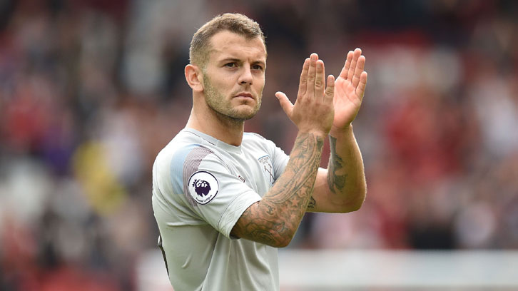 Jack Wilshere applauds the West Ham supporters at Anfield