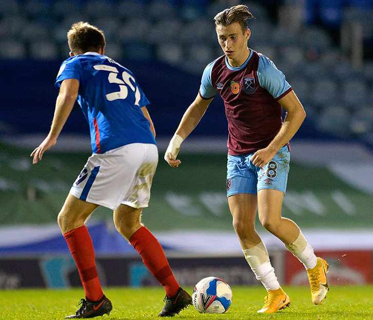 Corbett takes on a Portsmouth defender at Fratton Park in the Papa John's Trophy