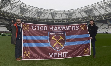 Lee Vehit (left) displays his flag with West Ham United Supporter Services Manager Jake Heath
