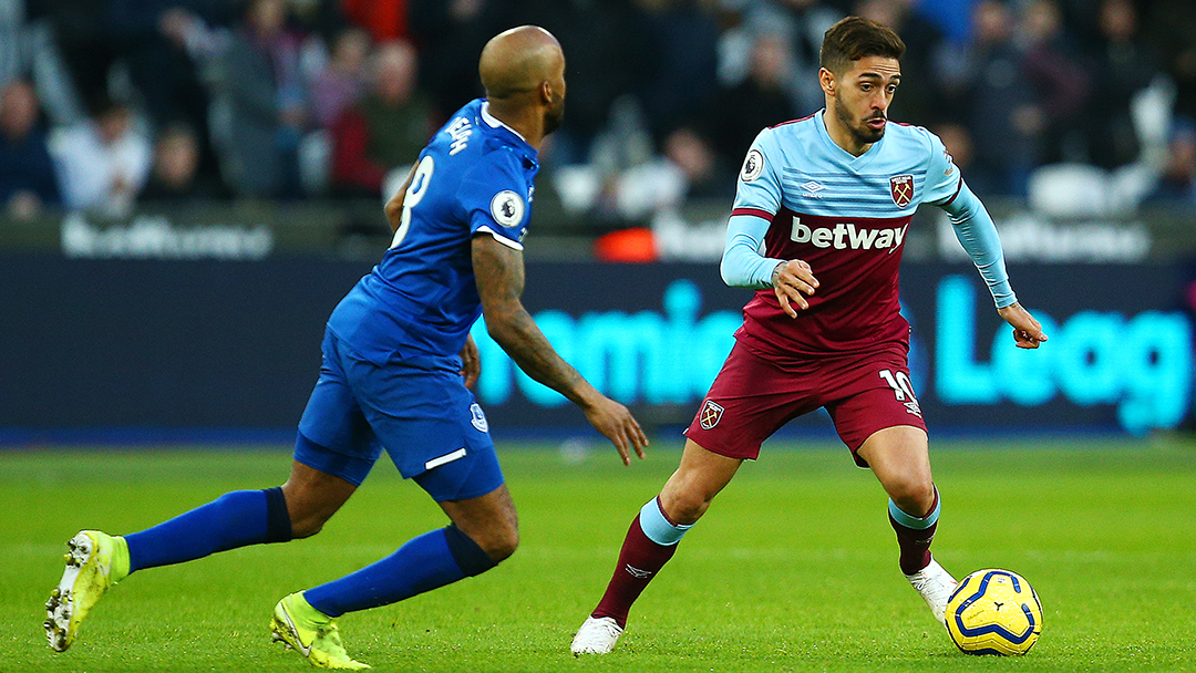 Manuel Lanzini vies for the ball for West Ham United
