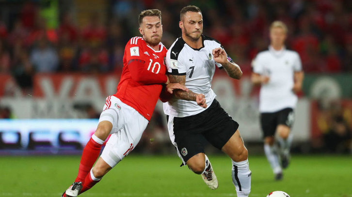Marko Arnautovic and Aaron Ramsey compete for the ball