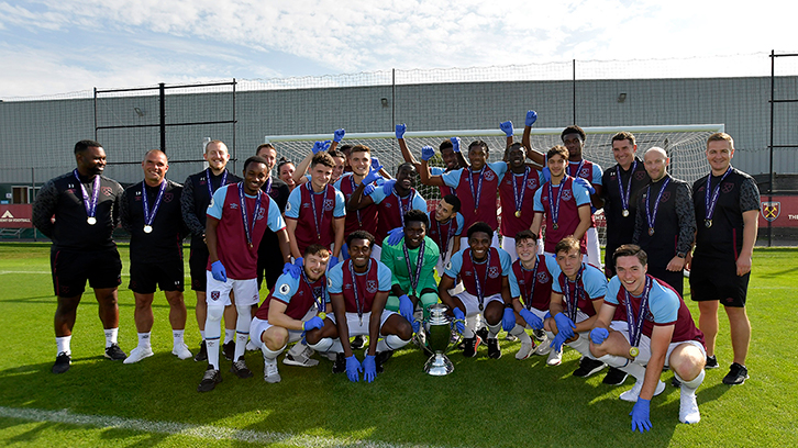 The Under-23s players and staff celebrate with the trophy